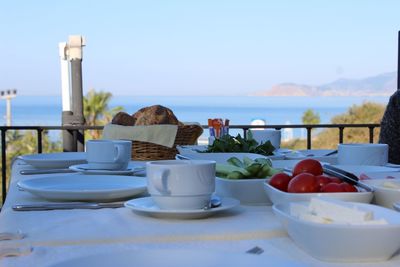 Breakfast on table against sea and sky