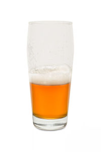 Close-up of beer glass against white background