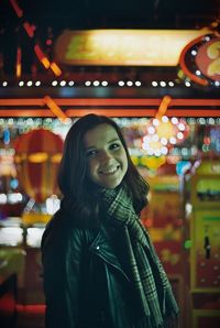 Portrait of smiling young woman at amusement park