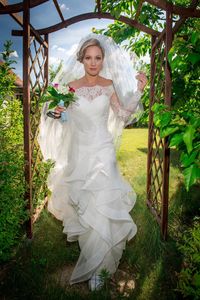 Portrait of bride running on field