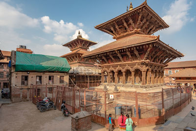 Group of people outside temple against building