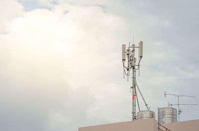 Low angle view of communications tower against sky