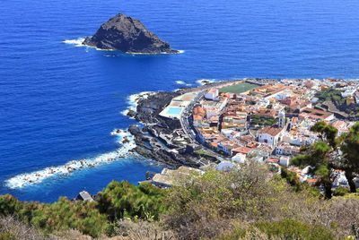 High angle view of townscape by sea