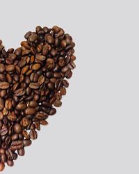 Close-up of coffee beans against white background