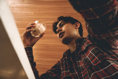 Portrait of young man drinking coffee
