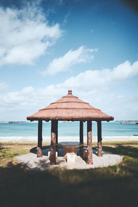 Lifeguard hut on beach against sky