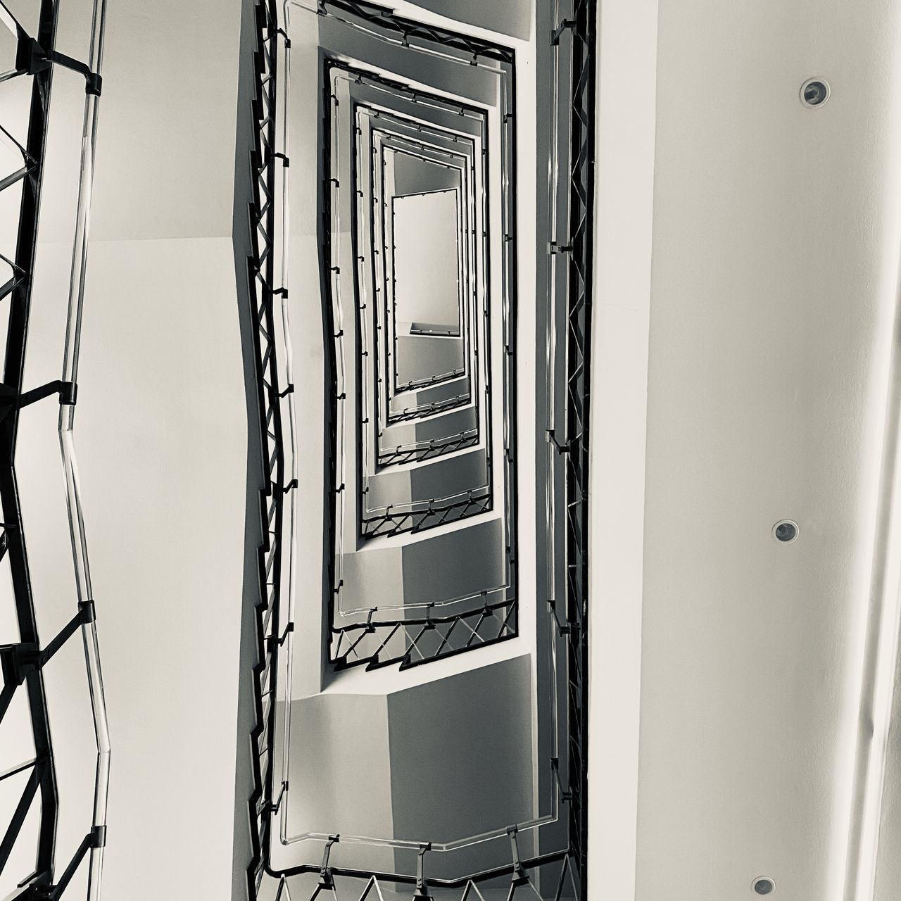 DIRECTLY BELOW SHOT OF SPIRAL STAIRCASE IN BUILDING