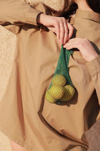 Midsection of woman holding fruits