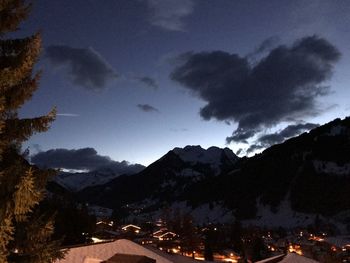 Scenic view of silhouette mountains against sky at night