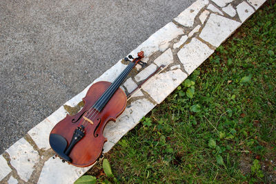 High angle view of guitar on footpath