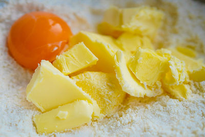 Ingredients for baking in stainless steel bowl eggs, sugar and butter