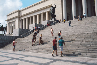 Group of people walking in front of building