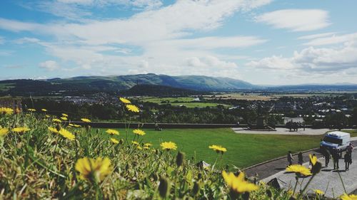 Scenic view of landscape against cloudy sky