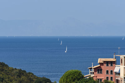 Scenic view of sea and buildings against sky