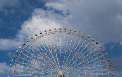 Ferris wheel against blue sky in osaka / japan
