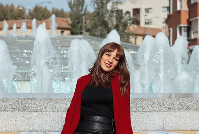 Portrait of smiling young woman standing outdoors