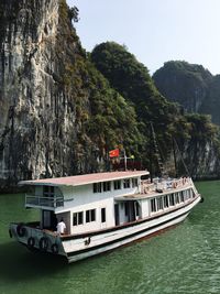 Boat on bridge over river against trees
