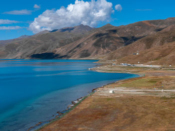 Scenic view of sea and mountains against sky