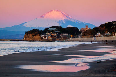 Scenic view of snowcapped mountains during sunrise