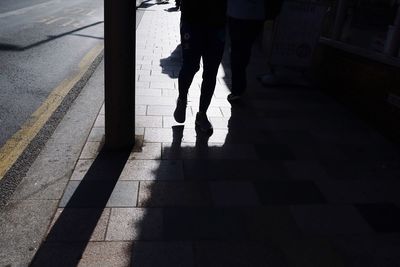 Low section of man walking on footpath