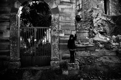 Rear view of man standing against building