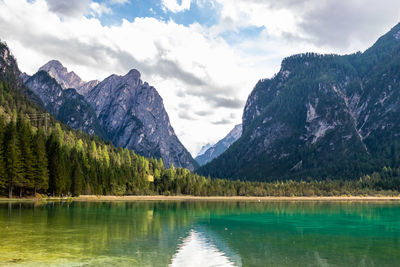 Scenic view of lake and mountains against sky