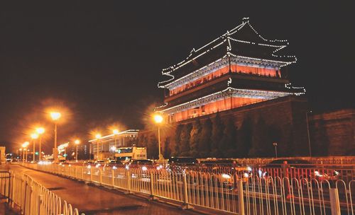 Illuminated bridge at night