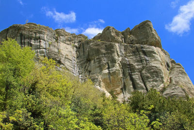 Low angle view of rocks against sky