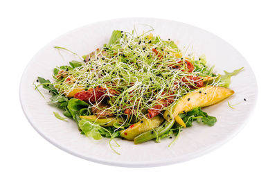 Close-up of food in plate on white background