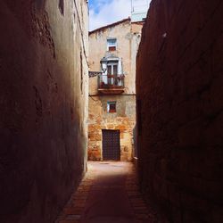 Alley amidst buildings against sky