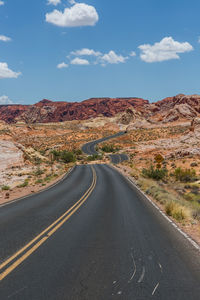 Road towards mountain against sky