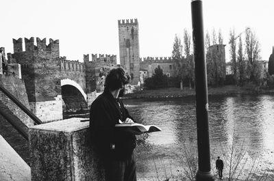 Woman sitting on wall