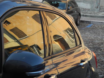 Close-up of vintage car on road