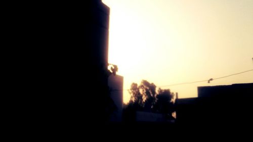 Silhouette person against sky during sunset