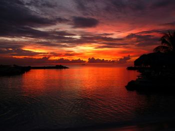 Scenic view of sea against cloudy sky at sunset