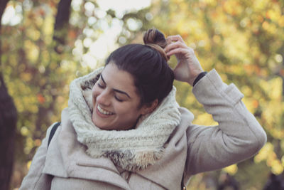 Beautiful smiling woman in park during winter