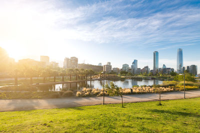 Scenic view of river by buildings against sky