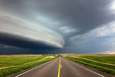 Straight road with dramatic storm clouds in montana