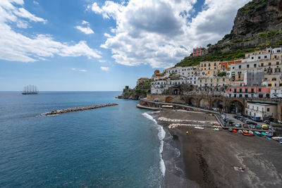 Panoramic view of sea and buildings against sky