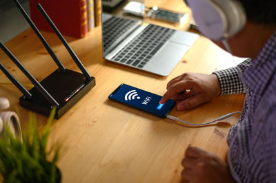 High angle view of man using laptop on table