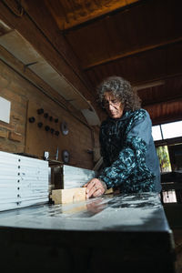 Woman looking up while sitting in kitchen