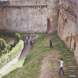 People walking in front of historic building