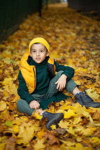 Portrait of young woman sitting on field