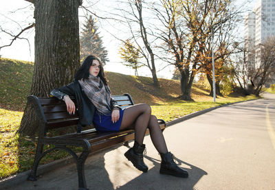 Young woman sitting on road