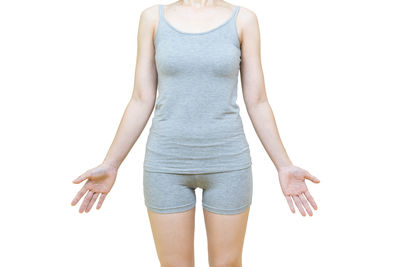 Midsection of woman standing against white background