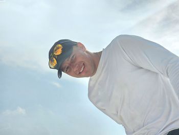 Low angle view of man standing against sky