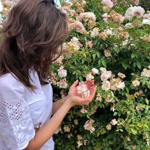 High angle view of woman holding flower