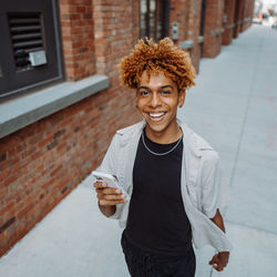 Portrait of young woman using mobile phone