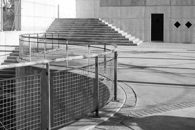 Staircase of building with rhomboidal windows and meandering railings