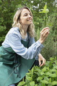 Young woman smiling while standing in farm